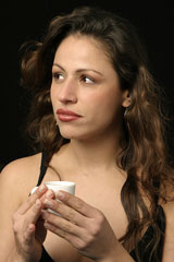 pensive Brazilian woman, holding a cup of coffee